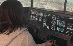 Alyvia Valentin, an aspiring astronaut, practices flying on Atlantic County Institute of Technology’s full motional Redbird simulator as part of her aviation studies coursework at the high school.