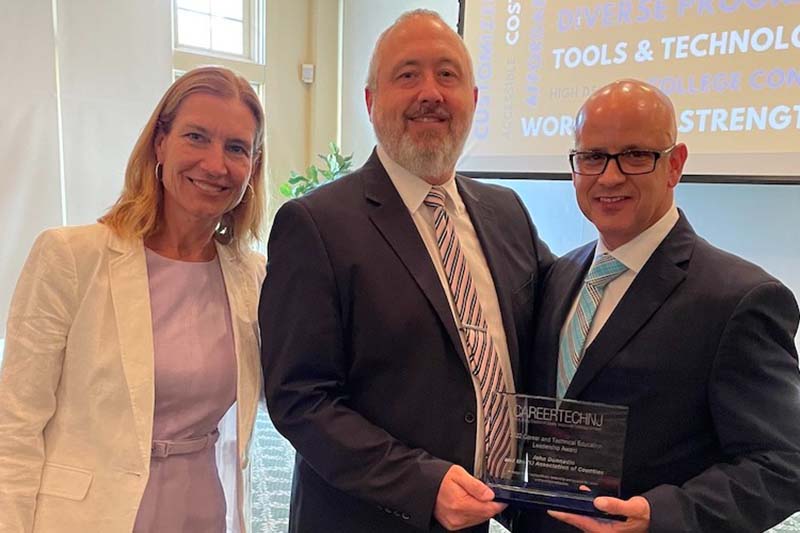 NJAC Executive Director John Donnadio accepts the CTE Leadership Award from Jackie Burke and James Pedersen