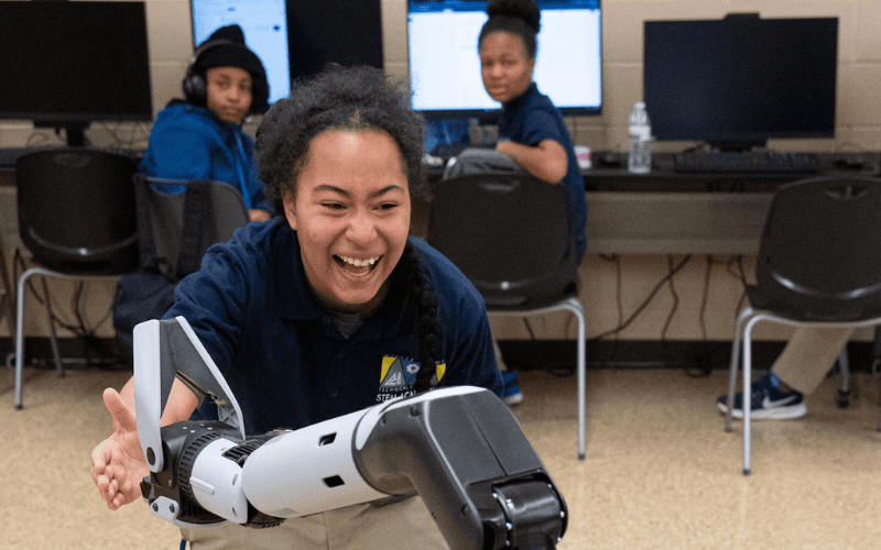 Student interacting with Robot