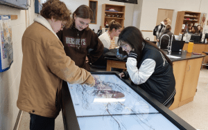 Hunterdon County Vocational School District’s Biomedical Sciences Academy students using the Anatomage table. Pictured from left to right are: Alex Ford, Mackenzie Holk and Ysabella Leonelli.