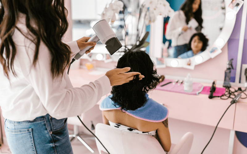 Hair stylist with client in chair