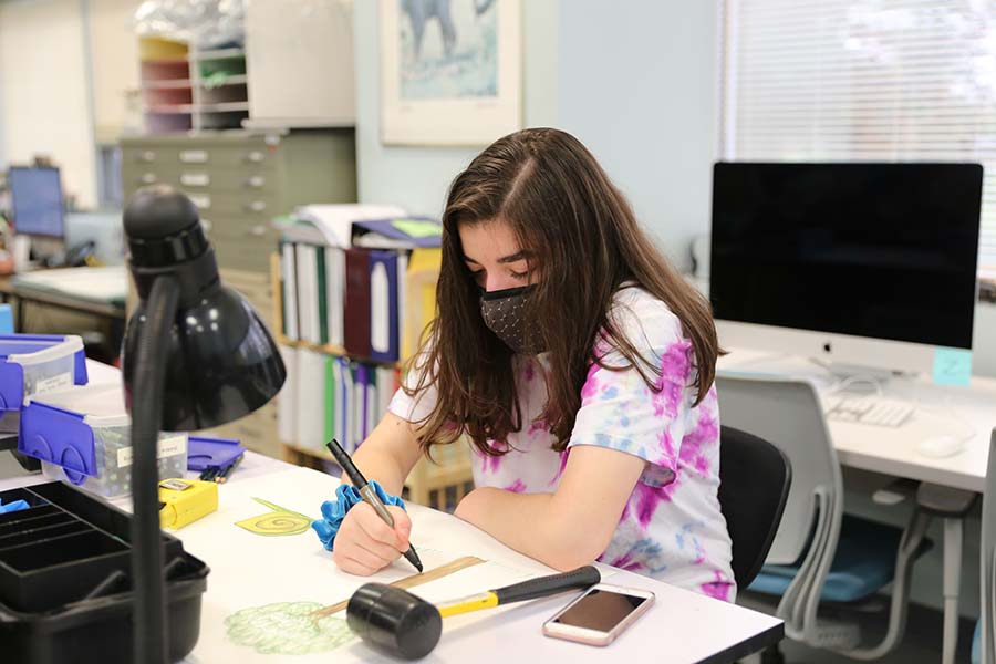 A Hunterdon County Vocational School District student sketches on a pad.