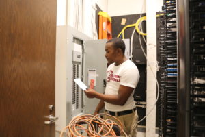 Jamil Brooks working on electrical panel