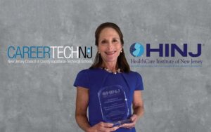 Judy Savage accepts award from HealthCare Institute of New Jersey