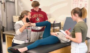 Laura Pinkman demonstrates sports medicine lesson