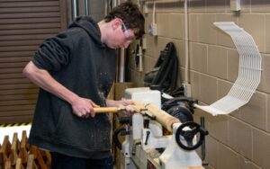 A student at Monmouth County's vocational-technical school uses tools in the carpentry classroom to round wood