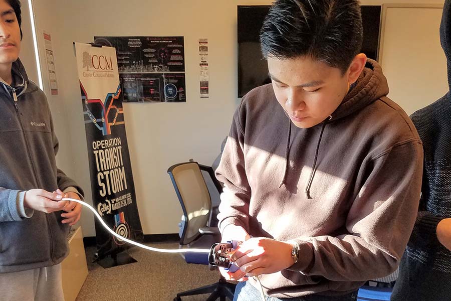 A Morris County student holds computer wires.