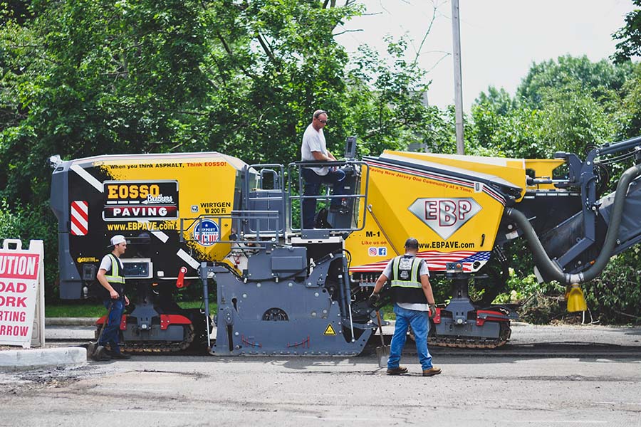 Ocean County students Stryder Rabender and Ben Brenner work on the job with EOSSO paving.