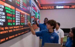 Passaic County vocational-technical students look at a stock exchange board in their classroom