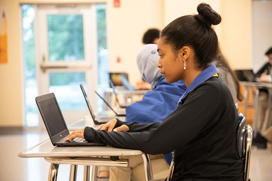 A Passaic County student studies on her laptop.