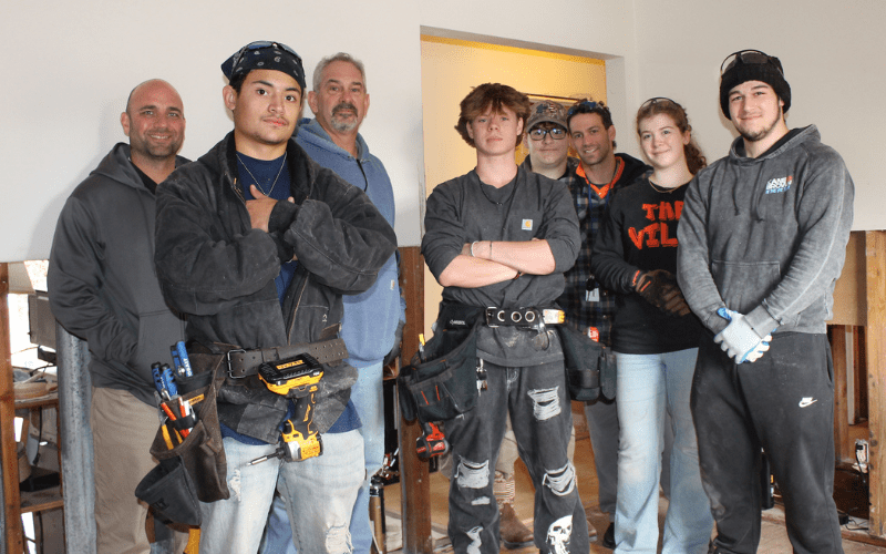 SCVTS construction students pose in a home they are working on