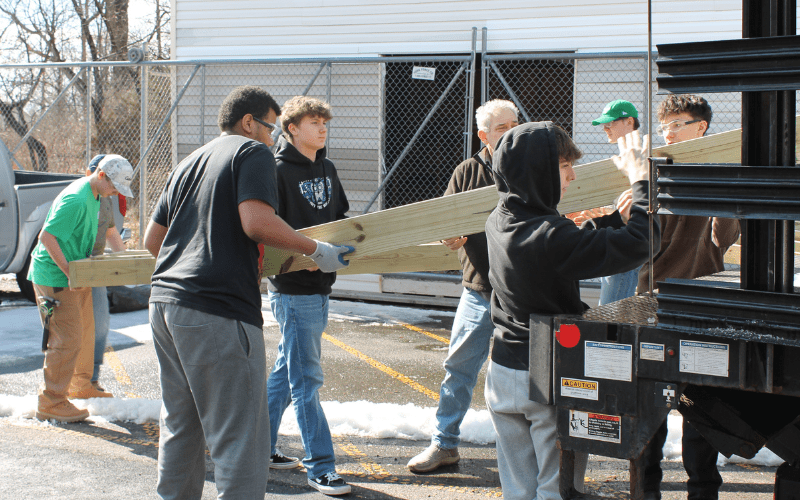 Carpentry students at Somerset County Vocational & Technical High School load wheelchair ramp components that they built to assist the Somerset County Handyman Project in their effort to provide accessibility for local residents. (Photo provided by SCVTHS)