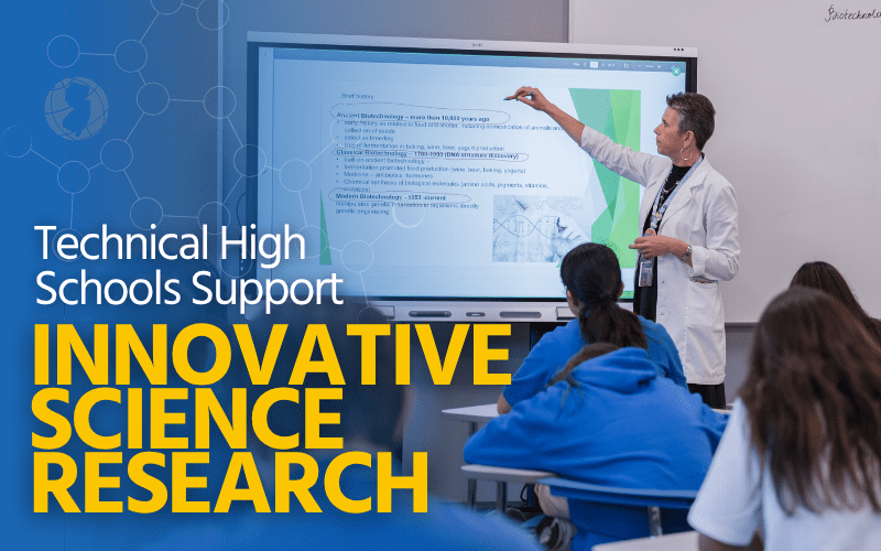 Technical High Schools Support Innovative Science Research teacher pointing to smart board with Biotechnology content on it