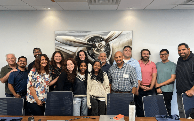 Hudson County High Tech High students from the Design and Fabrication Academy, pictured front and center, pose during their summer internship at STS Aerospace. Pictured fifth from left is High Tech High alumna Angelique Rivera, who forged a relationship between the school and STS Aerospace, where she is now employed as a manufacturing engineer.