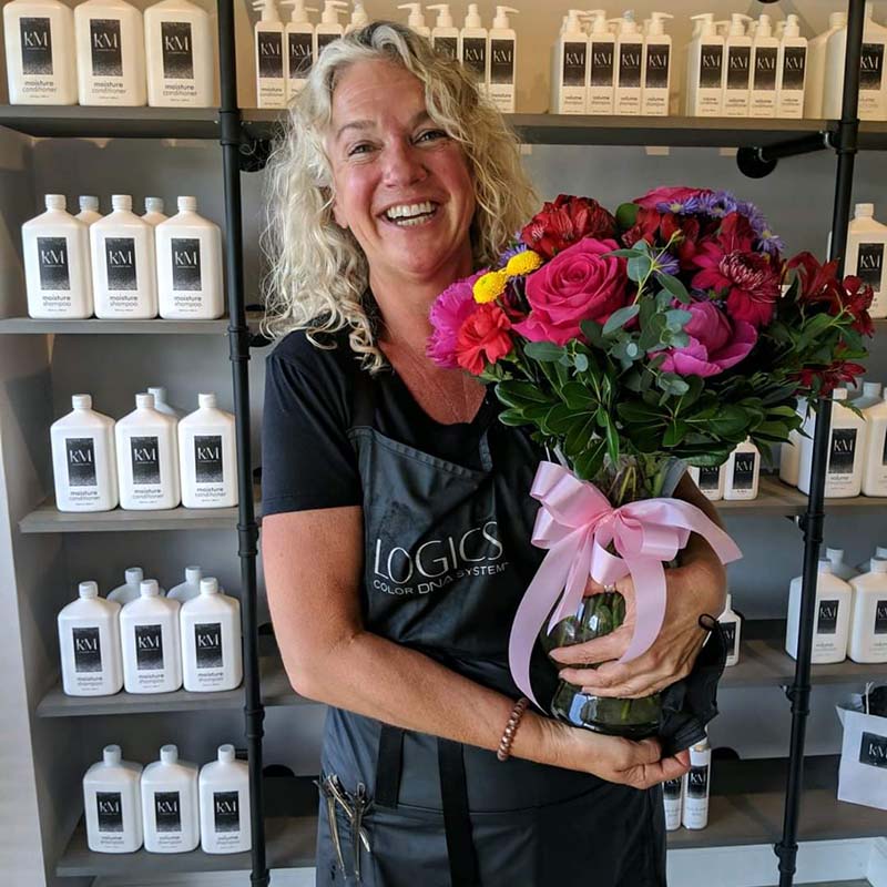 A hair stylist from Kristina Michelle Salon is presented with flowers as Warren County’s Business Partner of the Year.